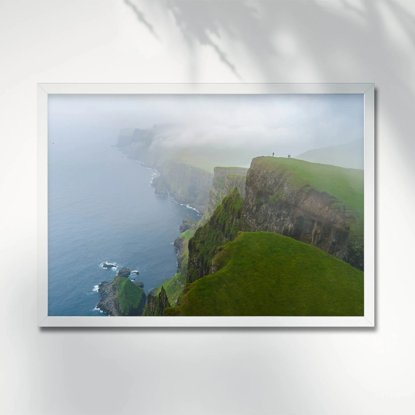Foggy cliffs overlooking a serene ocean. Island of Suðuroy. Faroe Islands