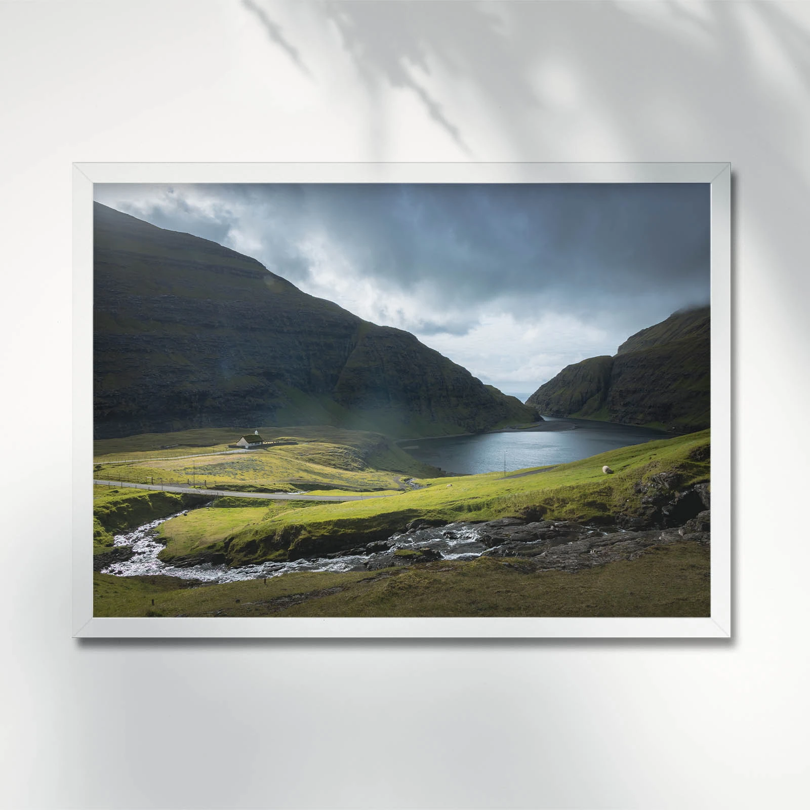 Lush valley with serene lagoon view. Saksun. Faroe Islands